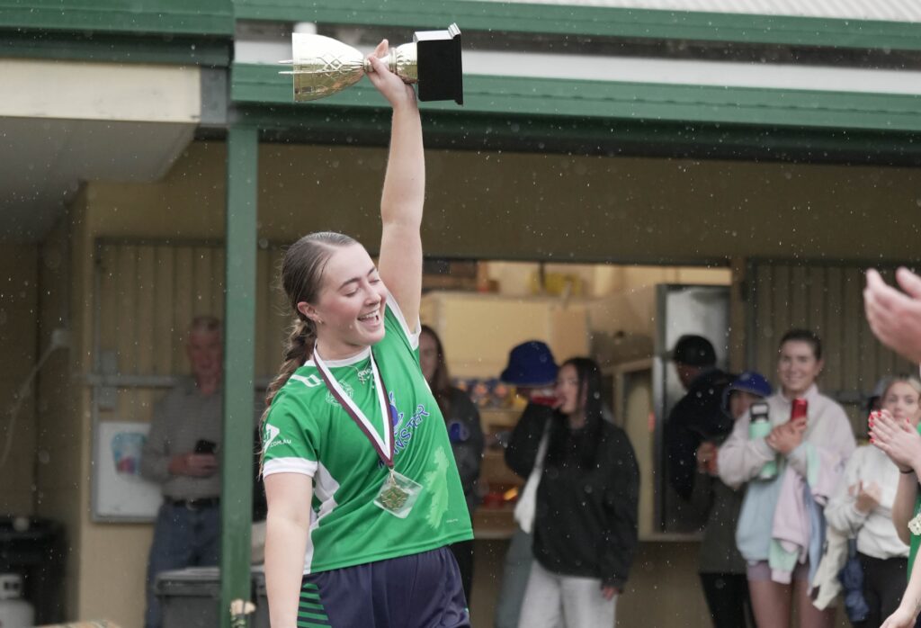 Emeralds camogie captain lifting a trophy