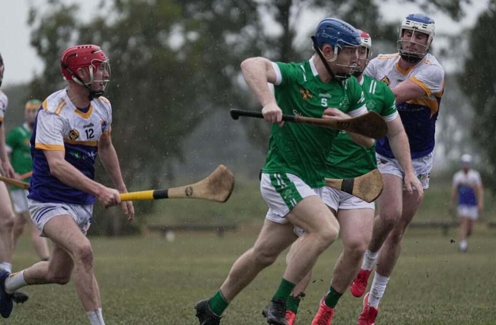 Emeralds and Gold Coast Gaels players during a hurling game