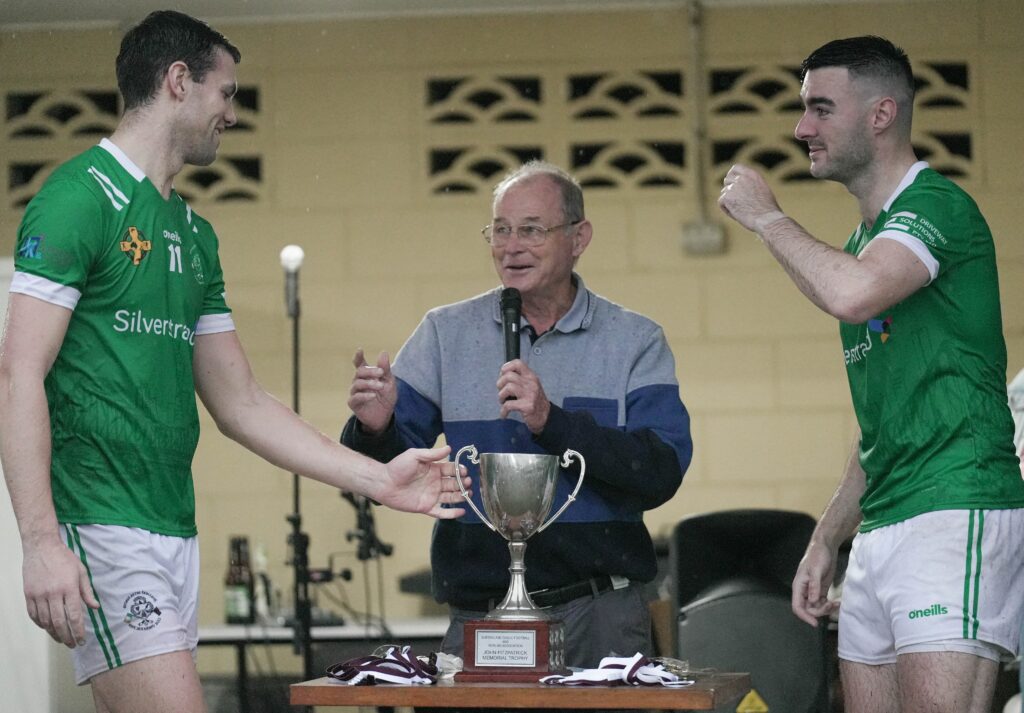 Emeralds hurling captains receiving the championship trophy