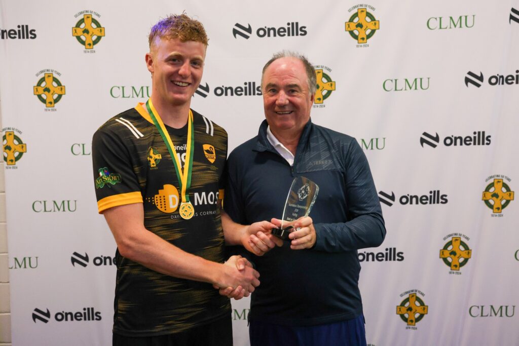 Derek Kent presenting WA's Calum Lyons with a man of the match award
