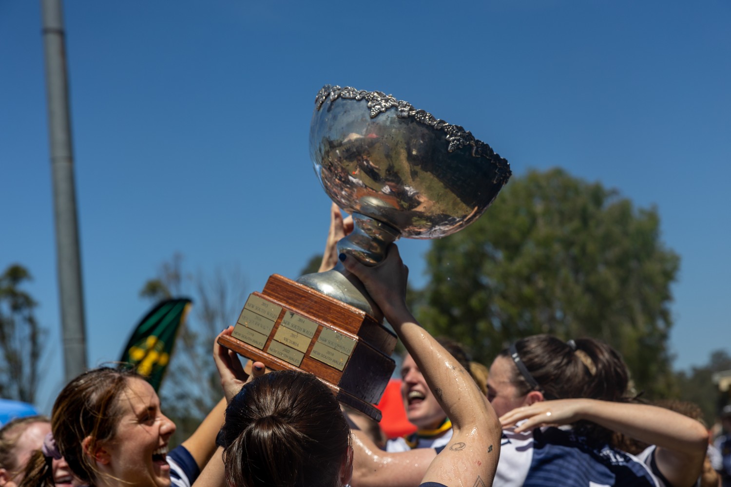 Victoria women's Gaelic footballers celebrating their Australasia Championships 2025 success in Brisbane