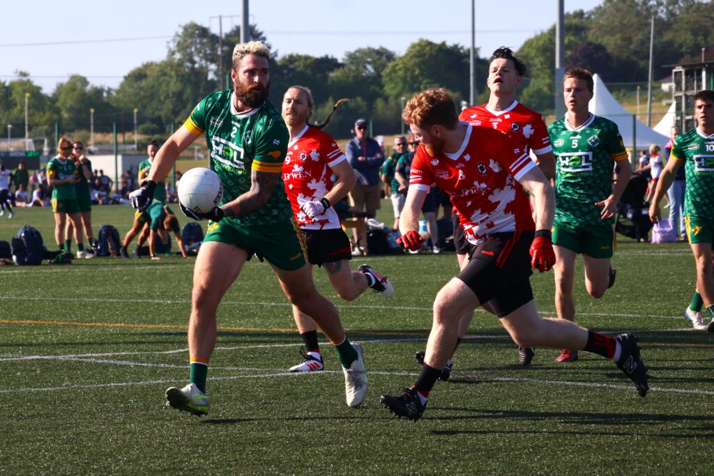 Australasia's Adam Smyth handpassing a ball against Canada at the 2026 GAA World Games.